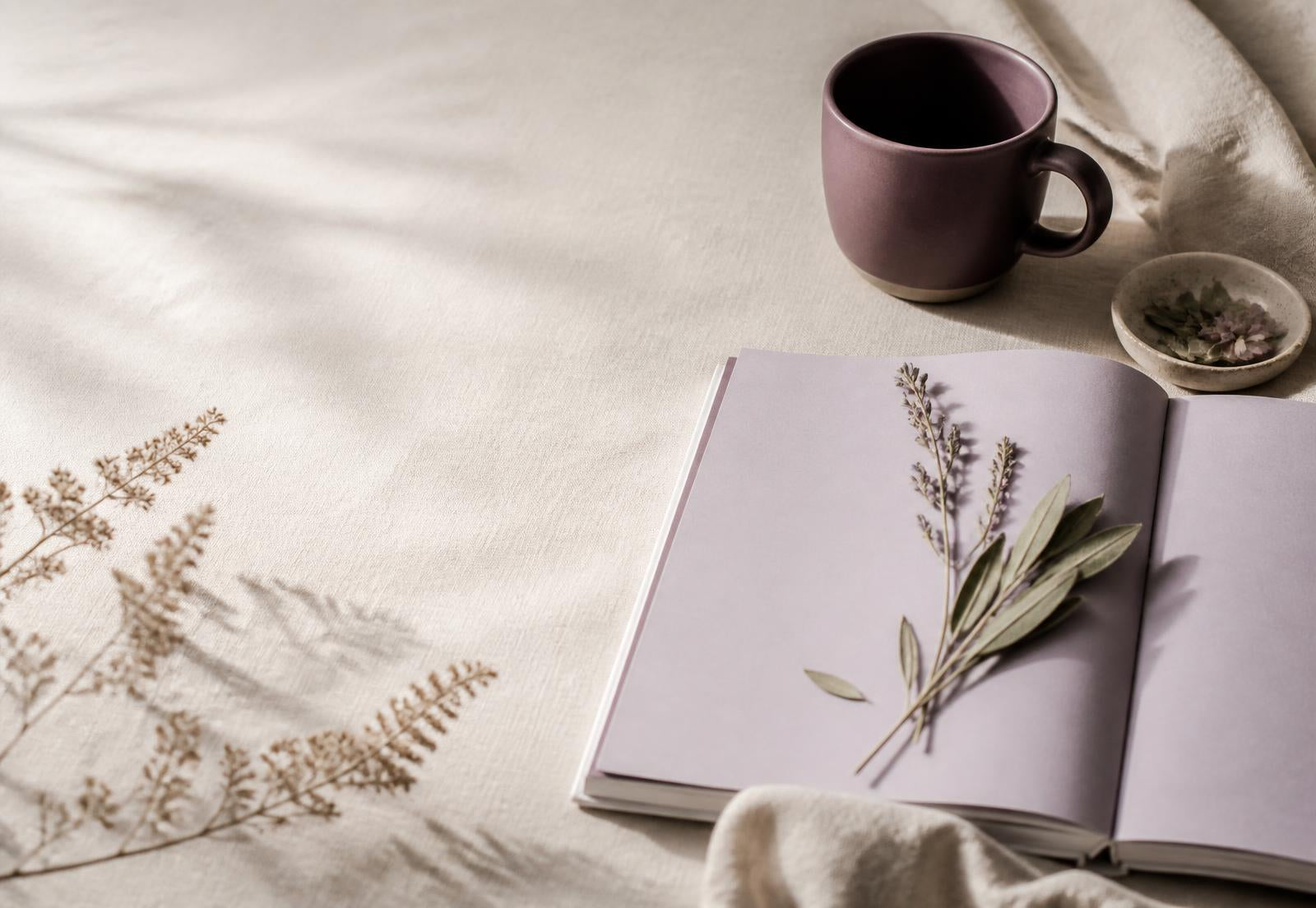 Calm, softly lit desk with printed therapeutic worksheets and a notebook